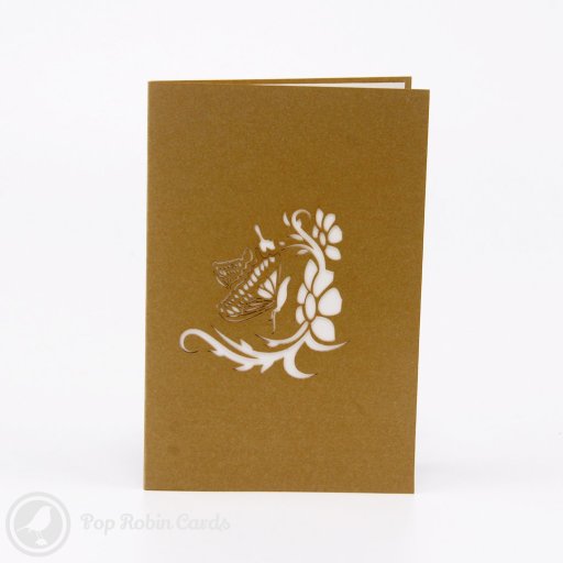 Two pop-up paper butterflies, one pale green and one pink, standing on white card pages with cut-out flower designs.
